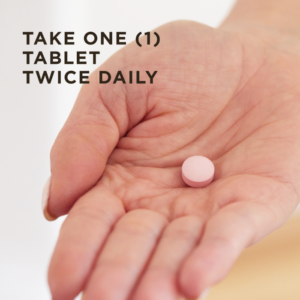 An image of a hand with one tablet of Solgar Women's Balancing Formula on it. The text on image reads, "Take one (1) tablet twice daily."