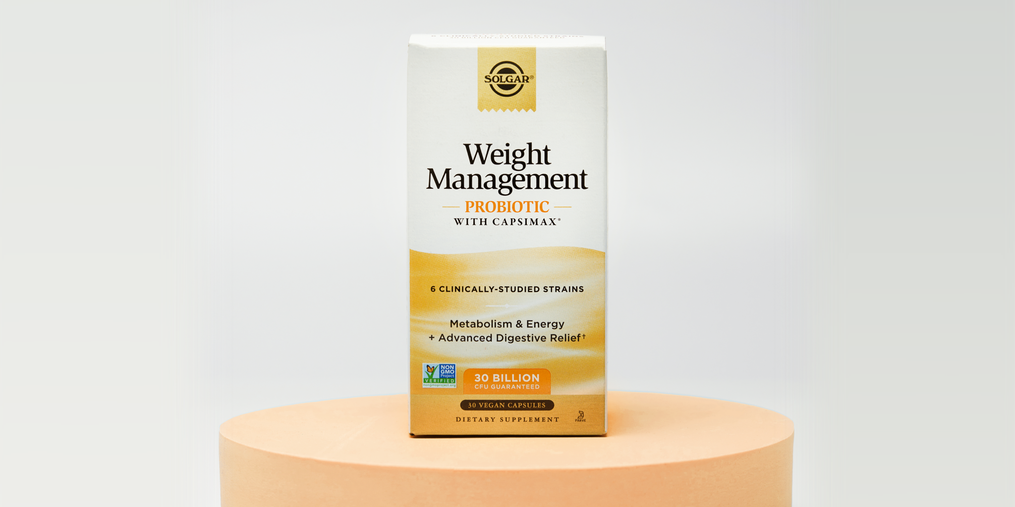 A box of Solgar Weight Management probiotic on top of an orange circular riser against a white background.