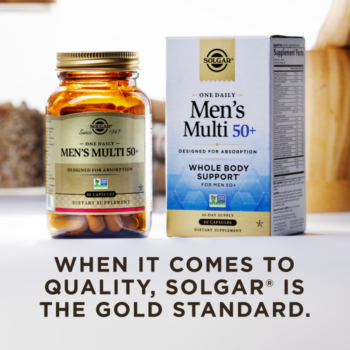 A box of Solgar One Daily Men's Multi 50+ with an amber glass bottle of the product beside it. The box and bottle are in a kitchen scene on a white countertop. The image says, "When it comes to quality, Solgar is the Gold Standard."