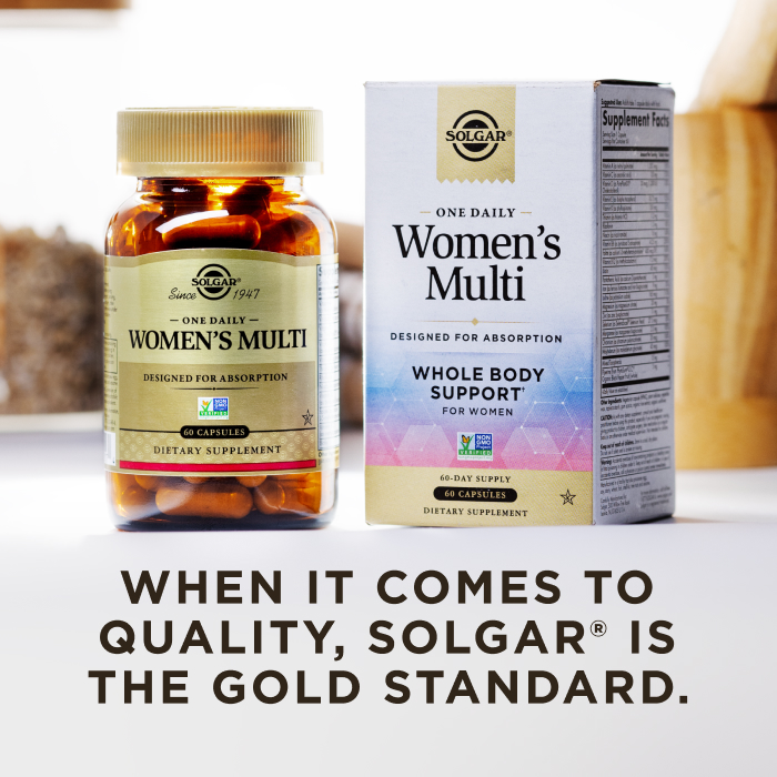 A box of Solgar One Daily Women's Multi with an amber glass bottle of the product beside it. The box and bottle are in a kitchen scene on a white countertop. The image says, "When it comes to quality, Solgar is the Gold Standard."