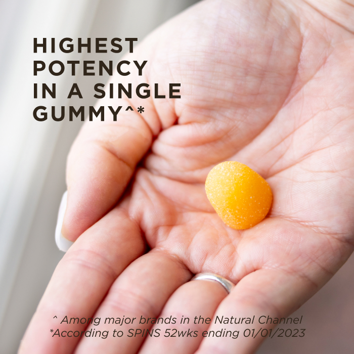 A person's hand with one serving of Solgar Ultra Potency Vitamin C Gummies in it. The gummy is orange as it is tart orange flavored. The image says, "Highest potency in a single gummy among major brands in the natural channel (according to SPINS 52 weeks ending 01012023)"