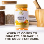 A bottle of Solgar Ultra Potency Vitamin C gummies in a kitchen scene on a white countertop. The image says, "When it comes to quality, Solgar is the Gold Standard."