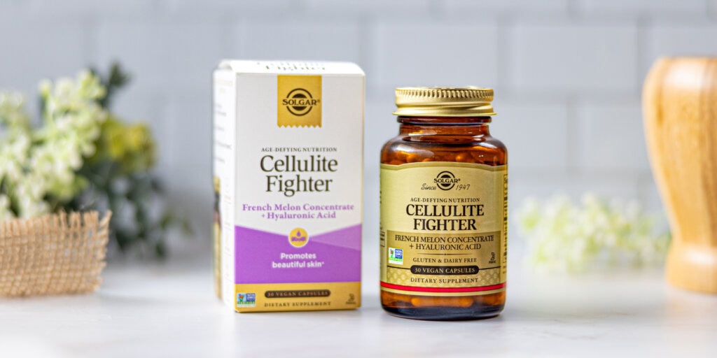 A box & bottle of Solgar Cellulite Fighter, sitting on a marble countertop in a clean, white kitchen setting. 