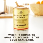 A container of Solgar's Brewer's Yeast Powder on a kitchen backdrop. Text reads "when it comes to quality, Solgar is the gold standard."