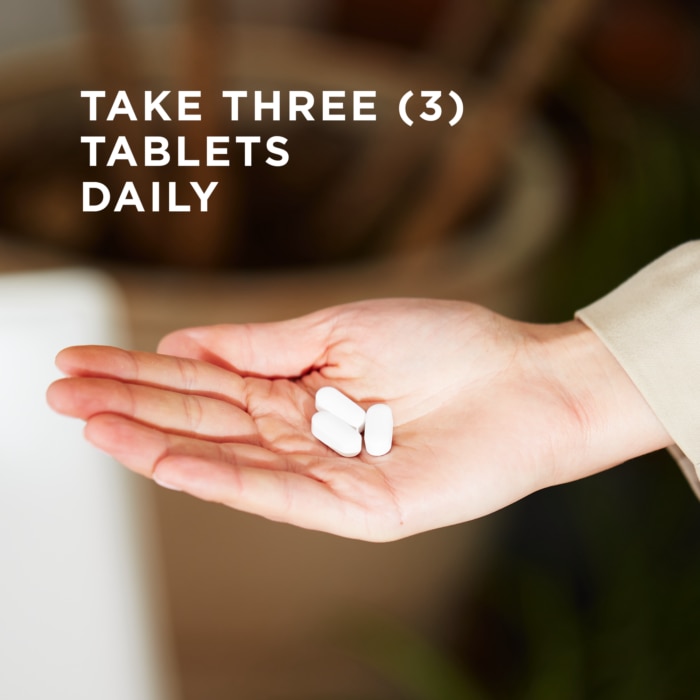 Three of Solgar's Calcium Magnesium Plus Zinc Tablets in an open palm, with text reading "take three tablets daily"