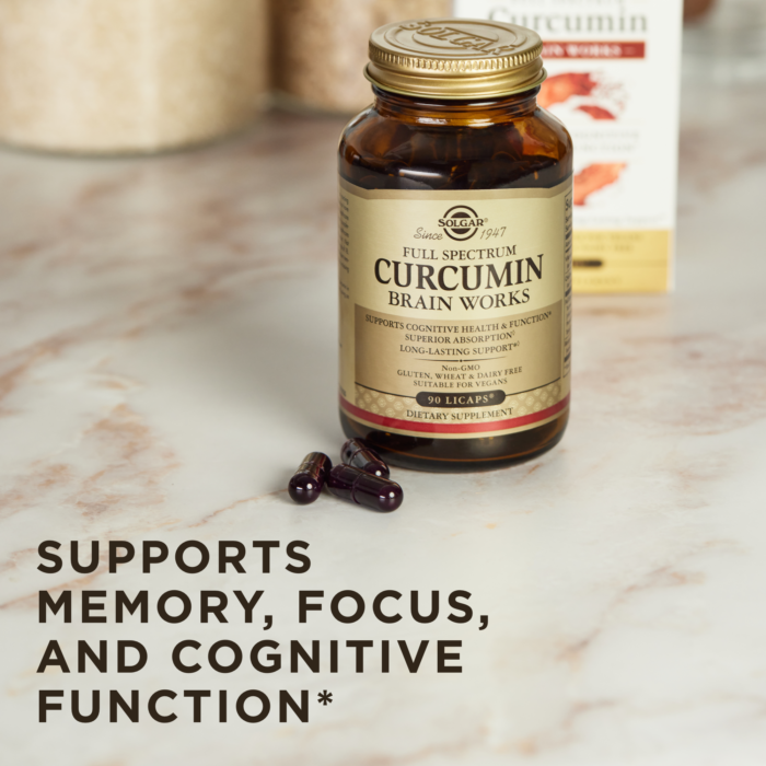 A bottle of Solgar's Full Spectrum Curcumin Brain Works Licaps™ lays face-up on a coral-colored surface. Text reads "advanced formula with bacomind, choline, vitamin b12, and full spectrum curcumin"
