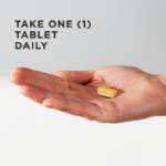 An outstretched hand holds a single Stress & Anxiety Relief tablet against a light background. Text overlaid reads "Take one tablet daily."