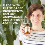 A smiling woman holds an amber glass bottle of Solgar's Stress & Anxiety Relief tablets up to the camera. Text on the image reads: "Made with plant-based ingredients: KSM-66®, Ashwagandha, and affron™ Saffron."
