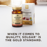 An amber bottle of Solgar's Menopause Relief Tablets next to its white-and-gold outer packaging on a white surface. Text overlaid reads: 'When it comes to quality, Solgar® is the Gold Standard.'