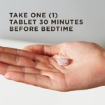 An outstretched hand holds a single Triple Action Sleep Tri-layer tablet against a light background. Text overlaid reads "Take one tablet daily."