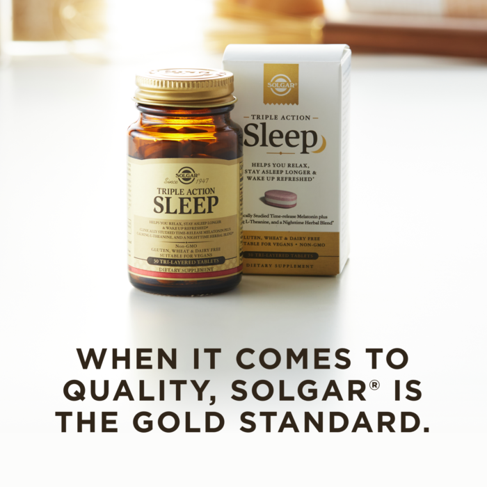 An amber bottle of Solgar's Triple Action Sleep Tri-layer tablets next to its white-and-gold outer packaging on a white surface. Text overlaid reads: "When it comes to quality, Solgar® is the Gold Standard."