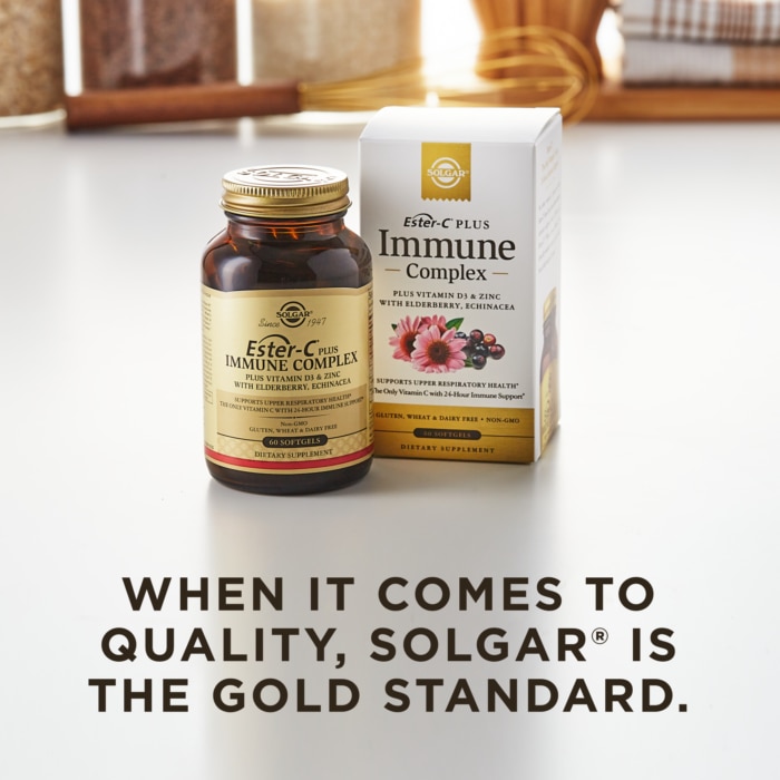 An amber bottle of Solgar's Ester-C® Plus Immune Complex softgels next to its white-and-gold outer packaging on a white surface. Text overlaid reads: "When it comes to quality, Solgar® is the Gold Standard."