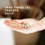 In a woman's upturned palm sits three of Solgar's Earth Source® Multi-Nutrient Tablets. Text reads "take three tablets daily"