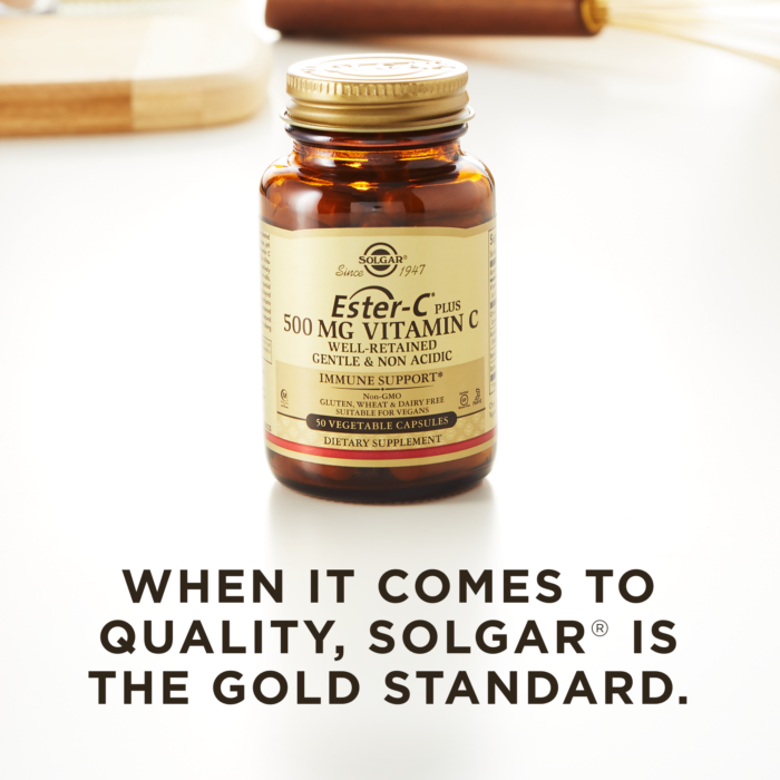 A bottle of Solgar's Ester-C® Plus 500 mg Vitamin C Vegetable Capsules (Ester-C® Ascorbate Complex) on a kitchen countertop. Text reads "When it comes to quality, Solgar is the gold standard."