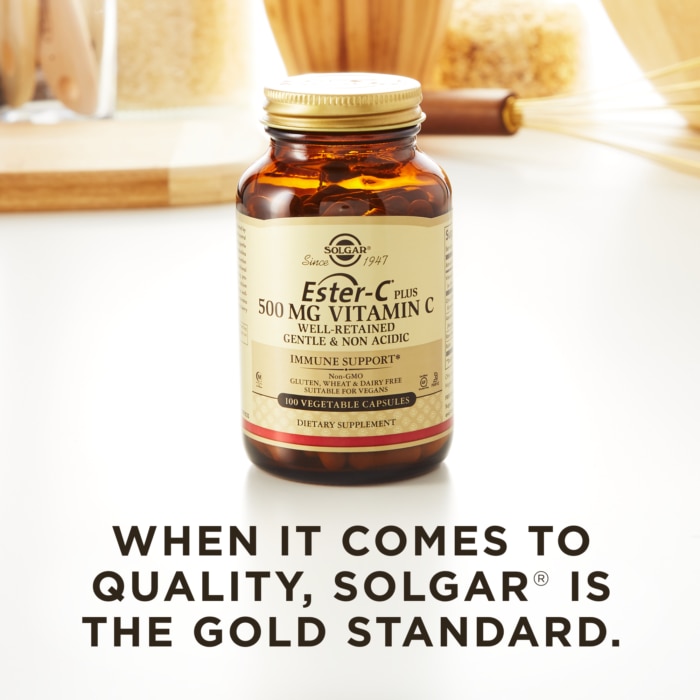 A bottle of Solgar's Ester-C® Plus 500 mg Vitamin C Vegetable Capsules (Ester-C® Ascorbate Complex) on a kitchen countertop. Text reads "When it comes to quality, Solgar is the gold standard."