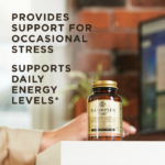 A bottle of Solgar's B-Complex "100" vegetable capsules on a desk next to a laptop, on which a person is typing. Text reads "provides support for occasional stress. Supports daily energy levels.*"