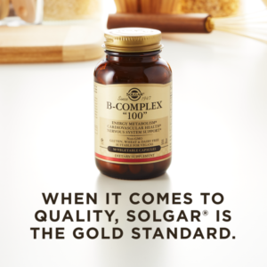 A bottle of Solgar's B-Complex "100" vegetable capsules on a kitchen surface. Text reads "when it comes to quality, Solgar is the gold standard."
