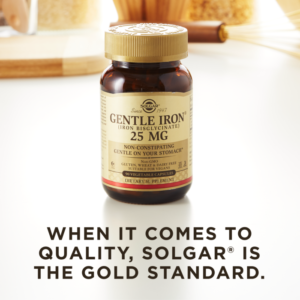 A bottle of Solgar's Gentle Iron Vegetable Capsules on a kitchen countertop. Text reads "When it comes to quality, Solgar is the gold standard."