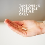 An outstretched hand holds a small vegetable capsule of Solgar's Gentle Iron. A text overlay reads: "Take one vegetable capsule daily."