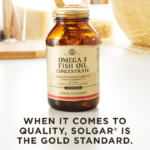 Solgar's Omega-3 Fish Oil Concentrate Softgels on a kitchen backdrop. Text reads "when it comes to quality, Solgar is the gold standard."