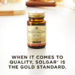 A bottle of Solgar's Methylcobalamin Vitamin B12 nuggets on a kitchen countertop. Text reads "When it comes to quality, Solgar is the gold standard."