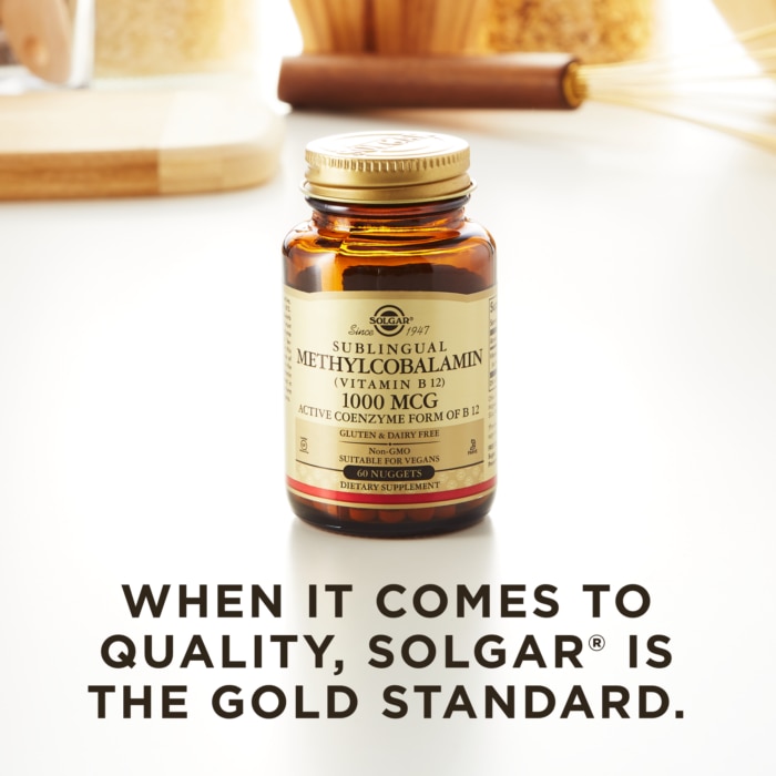 A bottle of Solgar's Methylcobalamin Vitamin B12 nuggets on a kitchen countertop. Text reads "When it comes to quality, Solgar is the gold standard."