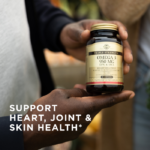 A person's hands holding a bottle of Solgar's Triple Strength Omega-3 softgels. Text reads: "Support heart, joint and skin health*"