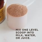 A cup of Solgar's Whey To Go® Protein Powder in Chocolate flavor sits on a counter. Text overlaid reads 