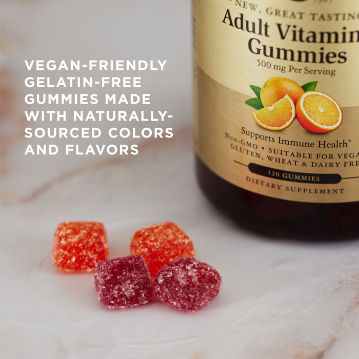 Four sugar-encrusted Solgar Adult Vitamin C gummies on a marble surface. Text overlaid reads 'vegan-friendly gelatin-free gummies made with naturally sourced colors and flavors'