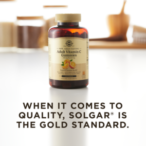 A bottle of Solgar Adult Vitamin C gummies on a clean surface. Text overlaid reads 'when it comes to quality, Solgar is the gold standard.'