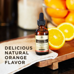 A bottle of Solgar's Liquid Vitamin D3 (Cholecalciferol) 125 mcg (5,000 IU) - Natural Orange Flavor on a surface next to orange halves. Text reads "delicious natural orange flavor"