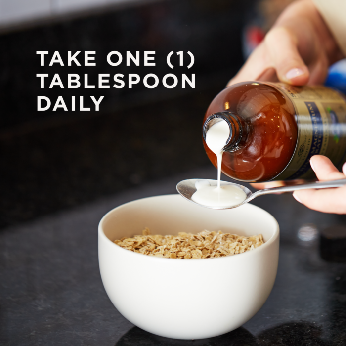 A bottle of Solgar's Liquid Calcium Magnesium Citrate with Vitamin D3 - Natural Blueberry Flavor pouring into a spoon held above a bowl of oats. Text reads "take one tablespoon daily"