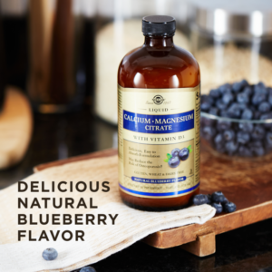A bottle of Solgar's Liquid Calcium Magnesium Citrate with Vitamin D3 - Natural Blueberry Flavor next to a bowl filled with blueberries. Text reads "delicious natural blueberry flavor"
