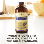 A bottle of Solgar's Liquid Calcium Magnesium Citrate with Vitamin D3 - Natural Blueberry Flavor on a kitchen surface. Text reads "When it comes to quality, Solgar is the gold standard."