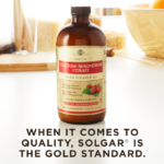 A bottle of Solgar's Liquid Calcium Magnesium Citrate with Vitamin D3 - Natural Strawberry Flavor on a kitchen surface. Text reads "When it comes to quality, Solgar is the gold standard."